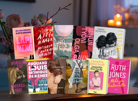 Erilaisia äitiysteemaisia kirjoja aseteltuja taustalle, josta erottuu epätarkkoina kukkakimppu ja kausivaloja,