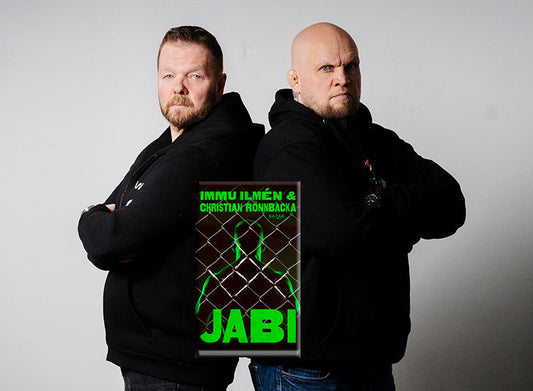 Kuva, jossa kirjailija Christian Rönnbacka ja entinen vapaaottelija Mika Ilmén poseeraavat selät vastakkain mustissa huppareissa. Heidän välissään näkyy heidän yhteisen kirjansa, Jabin, kansi vihreine siluetteineen ja häkkiverkkokuvioineen.